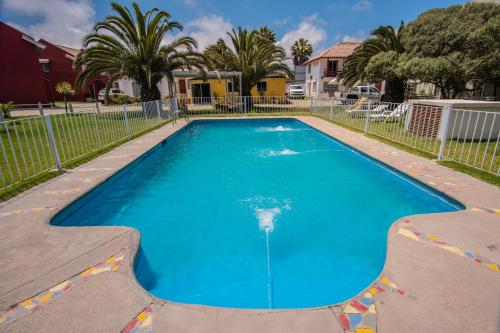 a large blue swimming pool in a yard at Cabañas Maihue in La Serena