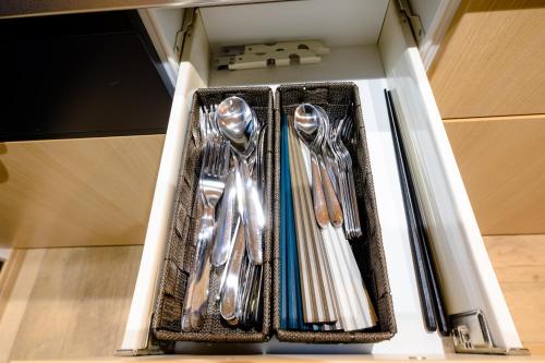 a drawer filled with silver utensils in a cabinet at enjoy Mt.Fuji B in Fujiyoshida