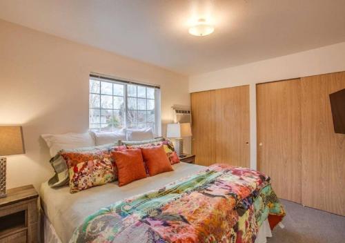 a bedroom with a large bed and a window at Luxe Leavenworth Cottage in Leavenworth