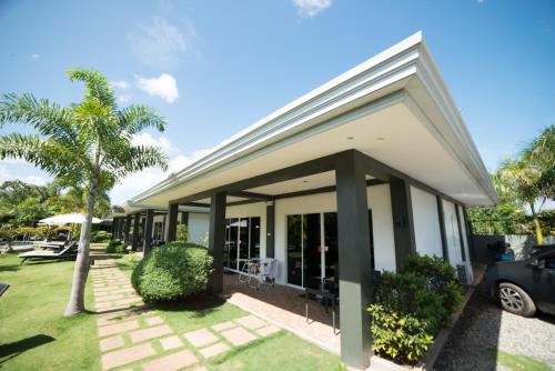 a house with a car parked in front of it at Alona Royal Palm Resort in Panglao