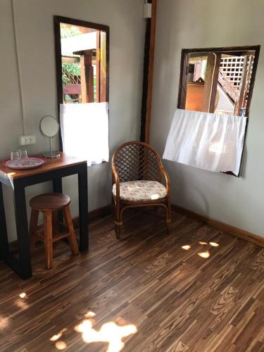 a room with a desk and a chair and a mirror at BAANYA HOMESTAY Ko Kret in Nonthaburi