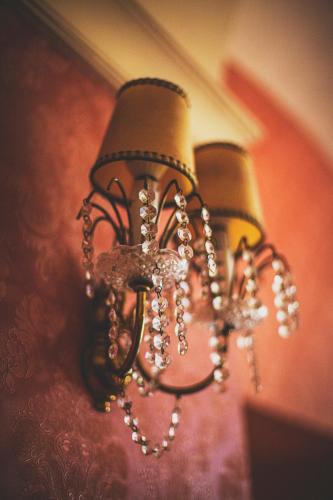 a chandelier is hanging from a wall at Pałac Brunów - Wellness & SPA in Lwówek Śląski