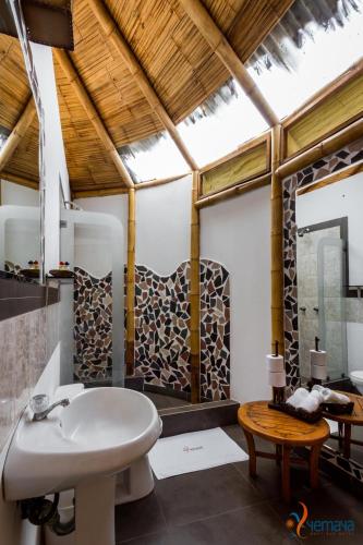 a bathroom with a white sink and a mirror at Yemaya Boutique Hotel en Canoas in Canoas de Punta Sal