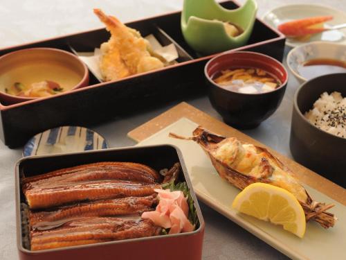 a tray of food with meat and other foods on a table at Crown Hotel Okinawa in Okinawa City