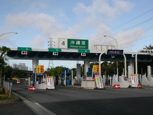 a gas station with a sign on top of it at Crown Hotel Okinawa in Okinawa City