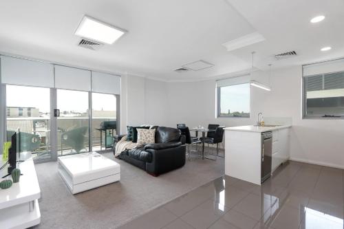 a living room with a couch and a table at 188 Apartments in Perth