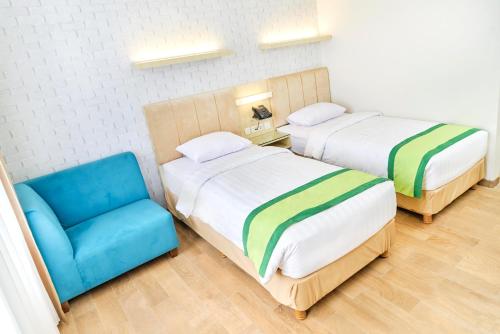 Hotel Wisata Niaga Campusにあるベッド