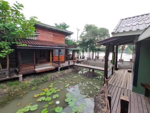 a pond in front of a building with lilies at BAANYA HOMESTAY Ko Kret in Nonthaburi