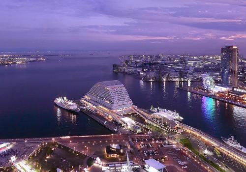 an aerial view of a city and the water at night at Kobe Meriken Park Oriental Hotel in Kobe