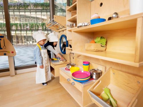 two children in chefsuits preparing food in a kitchen at Fame Hall Garden Hotel in Longtan