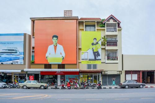 a building with a large billboard on the side of it at OYO 447 Royal Express Hua Hin in Hua Hin