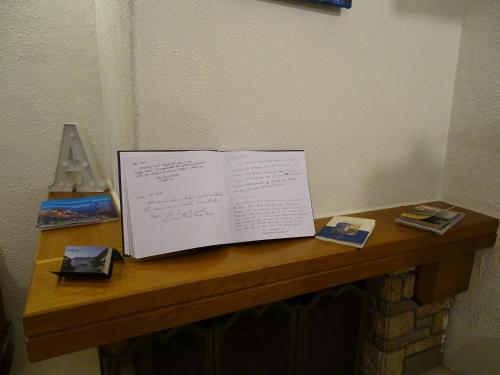 a table with a sheet of paper on it at Agretta Sea View Apartment in Vernazza