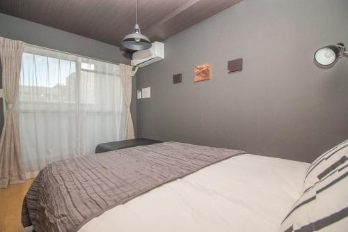 Кровать или кровати в номере Nakayoshi Stay 201