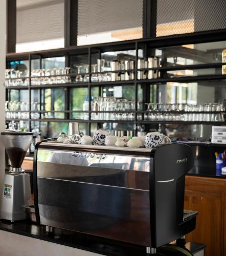 a kitchen with a counter with a toaster oven at The VELO'S Hotel and Pumptrack in Aranyaprathet