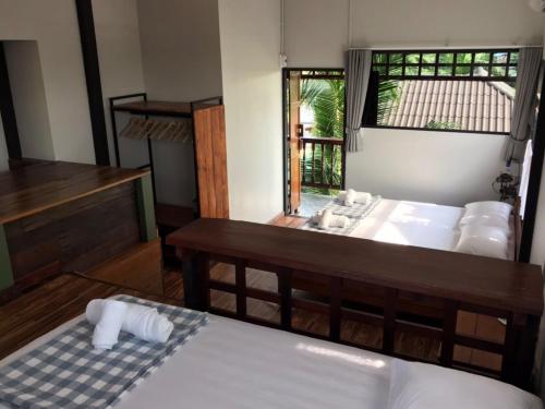 a bedroom with a bed and a sink and a mirror at BAANYA HOMESTAY Ko Kret in Nonthaburi