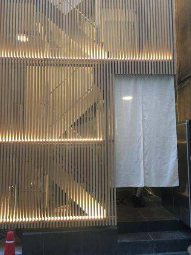a staircase with lights on the side of a building at Hotel 草石庵 in Osaka
