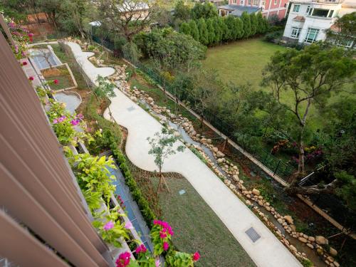 a view of a garden from a balcony at Fame Hall Garden Hotel in Longtan