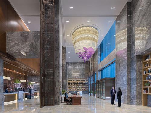a lobby of a building with people walking in it at Venus Royal Hotel(Foshan Kuiqi Road Metro Station) in Foshan