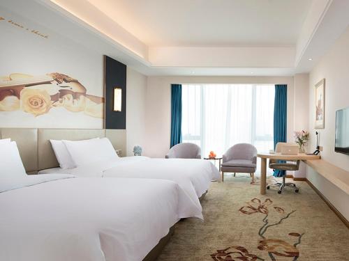 Postel nebo postele na pokoji v ubytování Vienna International Hotel (Changsha Ningxiang South Bus Station)