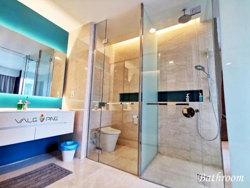 a bathroom with a glass shower with a toilet at Tropicana The Residences KLCC by Vale Pine in Kuala Lumpur