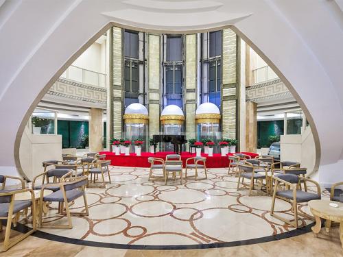 a room with tables and chairs in a building at Vienna Hotel(Nanjin Fuzimiao Muxuyuan Subway Station) in Nanjing