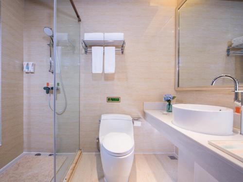 a bathroom with a toilet and a sink and a shower at Vienna 3 Good Hotel (Wuhu County Bus Station) in Wanzhi