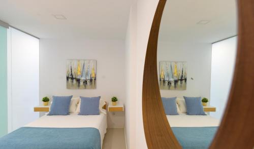 A bed or beds in a room at Apartamento Luis Morote Plaza Santa Catalina