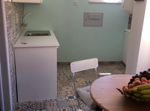 a kitchen with a table with a bowl of fruit at Dream View in Chiado in Lisbon
