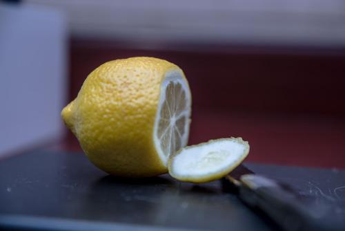 a sliced lemon sitting on top of a knife at Kyriad Saint-Malo Dinard in La Richardais