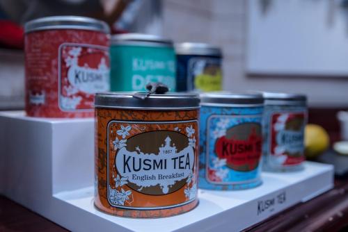 a row of cans of kussin tea on a shelf at Kyriad Saint-Malo Dinard in La Richardais
