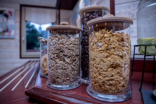 four glass jars filled with different types of cereal at Kyriad Saint-Malo Dinard in La Richardais