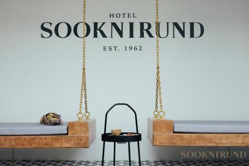 a room with two beds and a sign that reads hotel scotland at SOOKNIRUND HOTEL in Chiang Rai