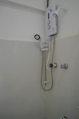a shower in a bathroom with a shower head at D'Villa Garden House in Jaffna