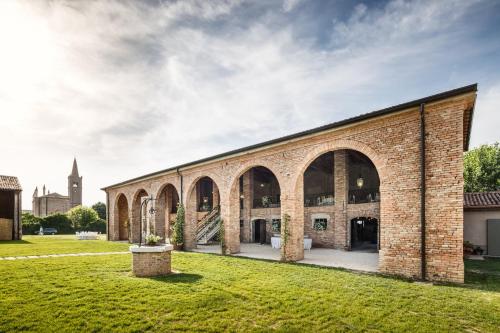 an old brick building with a grass yard at Il Gesuita in Mantova