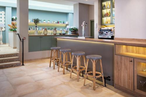 a bar with stools at a counter in a restaurant at Catalonia Santa Justa in Seville