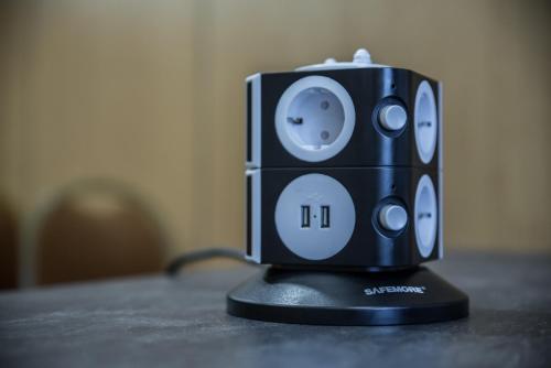 a black speaker sitting on top of a table at Mercure Dinan Port Le Jerzual in Dinan