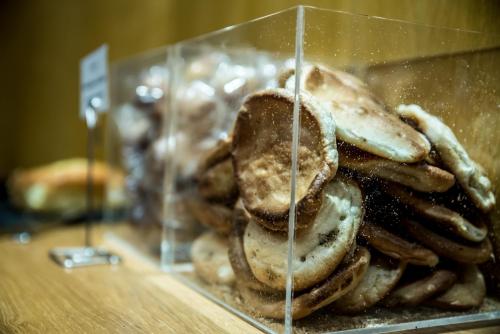 a pile of cookies in a glass display case at Mercure Dinan Port Le Jerzual in Dinan
