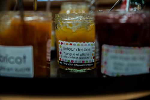 a jar of orange juice sitting on a table at Mercure Dinan Port Le Jerzual in Dinan