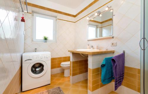 a bathroom with a washing machine and a sink at Istriana house in Banjole
