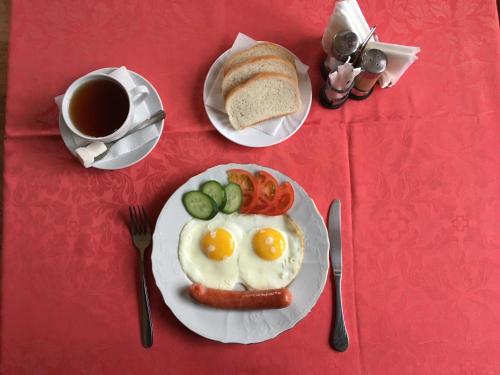 a plate of eggs and bread and a cup of coffee at Donskaya Riviera Hotel in Rostov on Don
