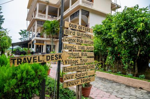 a street sign in front of a building at Hotel Riverside with Swimming pool in Sauraha