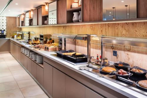 a buffet line in a restaurant with food at Catalonia Santa Justa in Seville