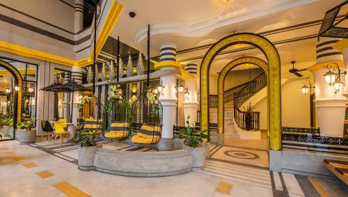 a lobby with chairs and a table in a building at The Twizt - Lifestyle Hostel & Hotel in Siem Reap