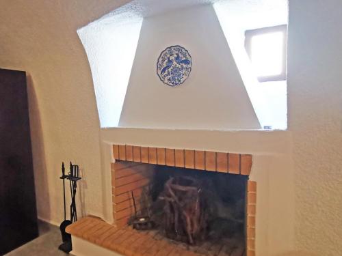 a fireplace with a plate on top of it at Guesthouse Toxotis in Pirgos Dhirou