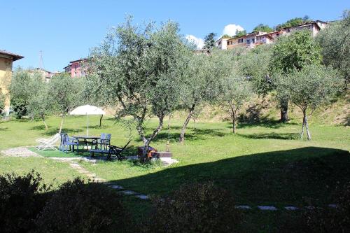 a park with a picnic table and an umbrella at Infinity in Tignale