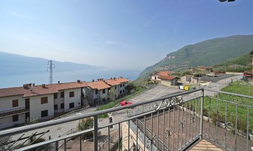 a view from a balcony of a town with a mountain at Infinity in Tignale
