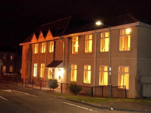 a lit up building on a street at night at Budget Hayat express hotel in Durham