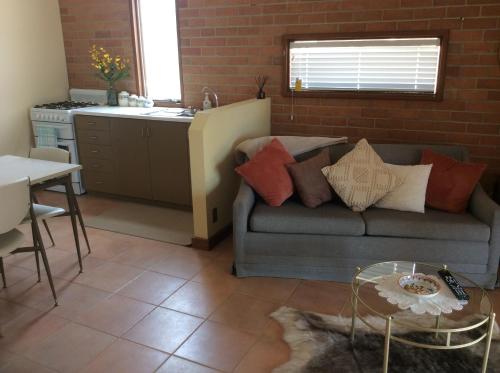 a living room with a couch and a table at Dunolly Broadway B&B in Dunolly