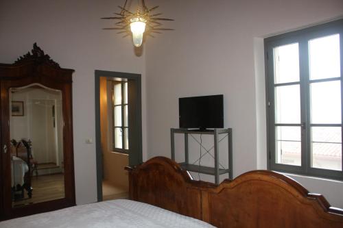a bedroom with a bed and a flat screen tv at Il Gesuita in Mantova