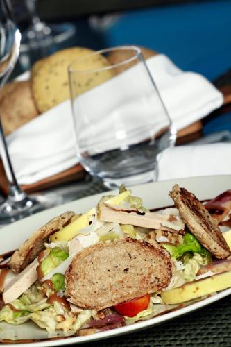 a plate of food with a sandwich on a table at Hotel Villa Didon Carthage in Carthage